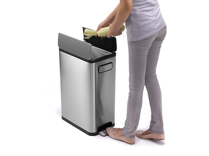 A woman is standing next to an Ecofly Kitchen Bin 30L.