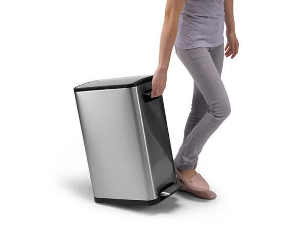 A woman is pushing an Ecofly Kitchen Bin 30L on a white background.